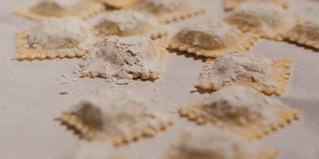 Ravioli with wilted greens and lemon